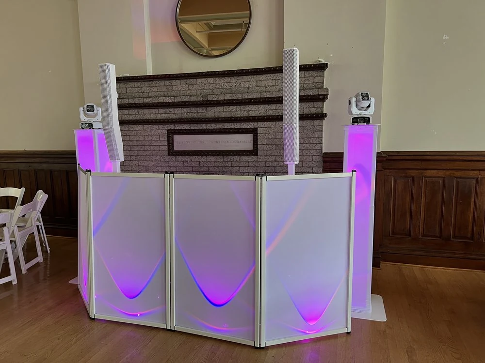 S and D white DJ booth with pink and purple uplighting